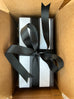 Black and white thick stripe paper with thick black grosgrain ribbon.